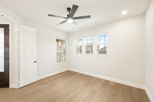 spare room featuring ceiling fan and light hardwood / wood-style floors