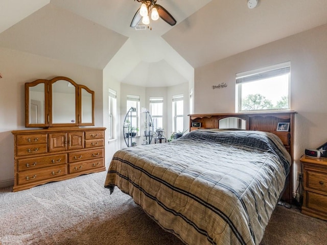 bedroom featuring multiple windows, lofted ceiling, and carpet flooring