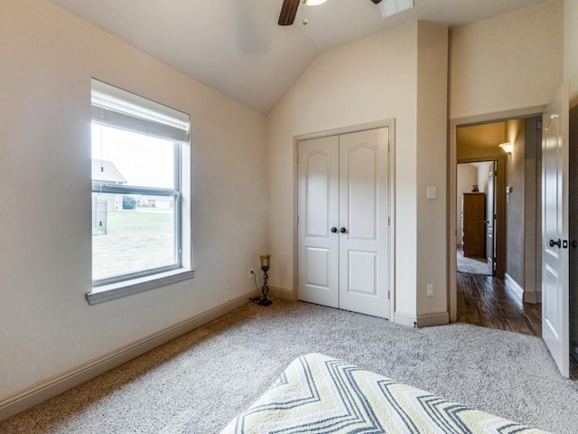 bedroom with ceiling fan, lofted ceiling, carpet floors, and a closet