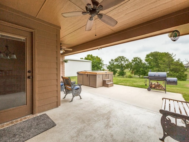 view of patio with a hot tub, grilling area, and ceiling fan