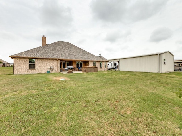 back of property with a yard and a patio