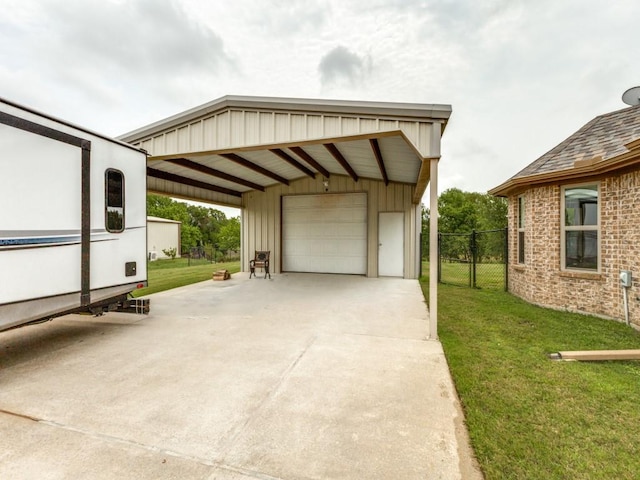 exterior space featuring an outbuilding, a garage, a lawn, and a carport