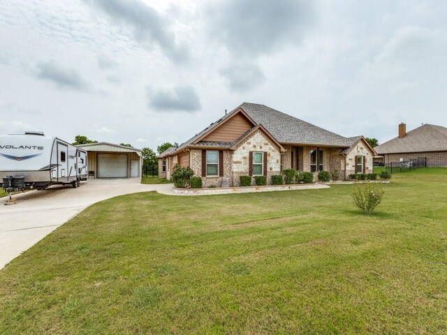 view of front of house with an outdoor structure, concrete driveway, a front lawn, a garage, and stone siding