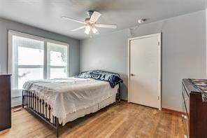 bedroom with ceiling fan and light wood-type flooring