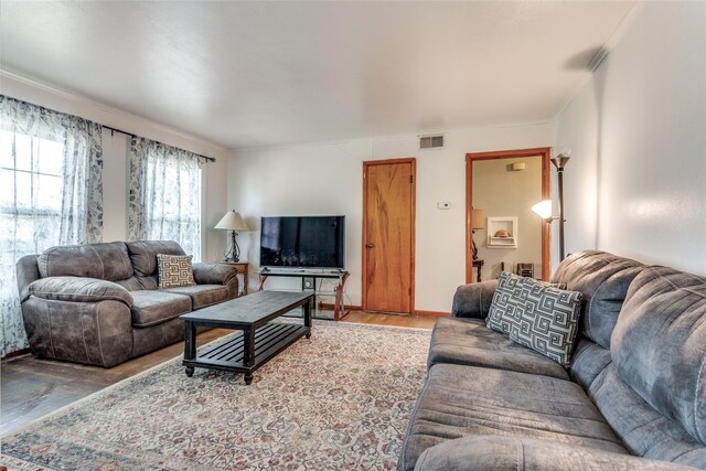 dining space featuring crown molding and light hardwood / wood-style flooring