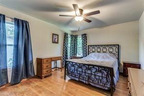 bedroom with ceiling fan and light hardwood / wood-style floors