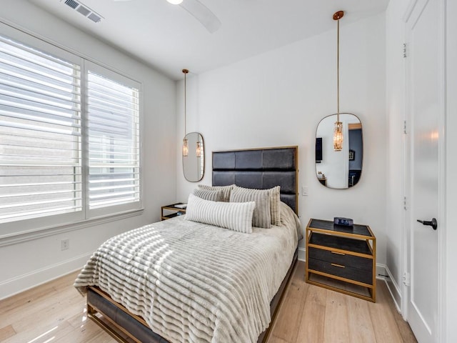 bedroom with ceiling fan and light wood-type flooring