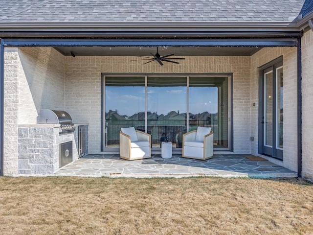 view of patio / terrace with ceiling fan, grilling area, and exterior kitchen