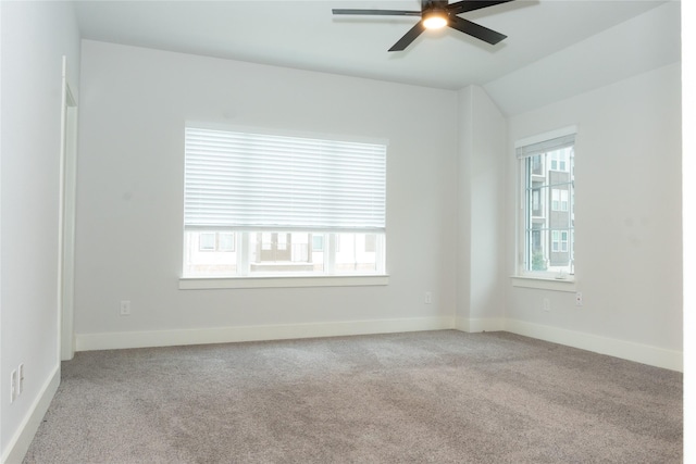 carpeted empty room with ceiling fan and vaulted ceiling