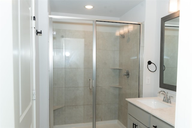 bathroom featuring vanity and a shower with shower door