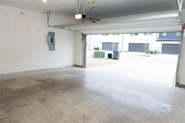 garage with a garage door opener and electric panel