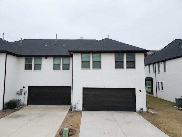 view of front of house with central AC unit and a garage