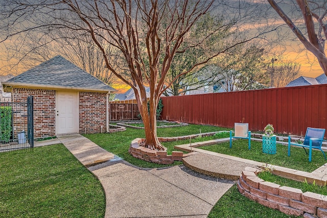 7405 Sugarbush Dr, Garland, TX 75044 - yard at dusk with a fenced backyard and an outbuilding