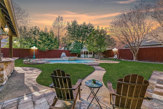 7405 Sugarbush Dr, Garland, TX 75044 - yard at dusk with a fenced backyard, a patio area, a pool with connected hot tub, and an outdoor structure