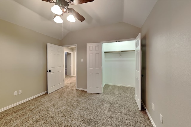 unfurnished bedroom with vaulted ceiling, light colored carpet, ceiling fan, and a closet