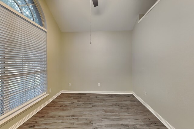 empty room with ceiling fan and wood-type flooring