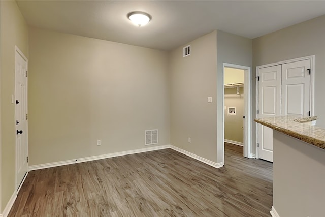 unfurnished room with hardwood / wood-style floors