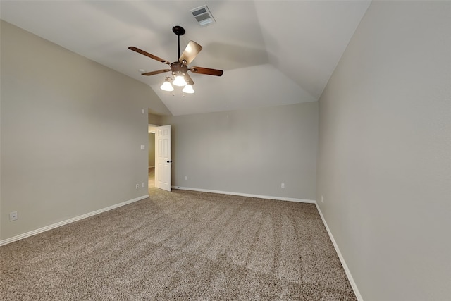 empty room featuring vaulted ceiling, carpet floors, and ceiling fan