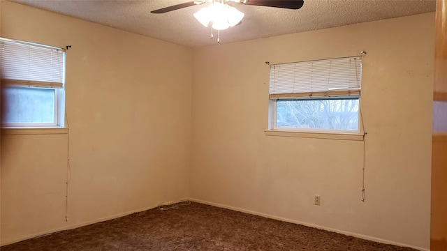 1802 SE 26th Ave, Mineral Wells, TX 76067 - spare room featuring a ceiling fan, dark colored carpet, and a textured ceiling