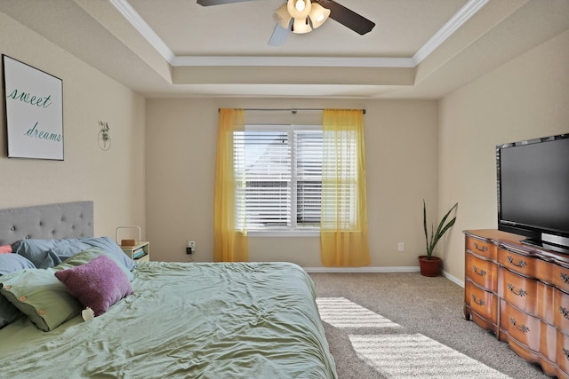 bedroom with ceiling fan, light colored carpet, ornamental molding, and a raised ceiling