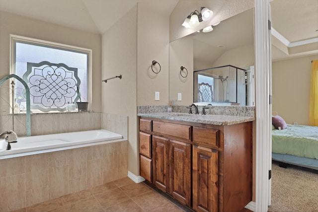 bathroom with vaulted ceiling, vanity, plus walk in shower, and tile patterned flooring