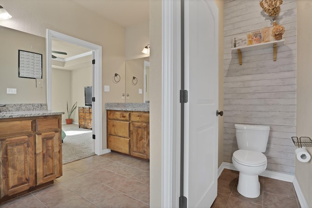 bathroom featuring vanity, toilet, and tile patterned flooring