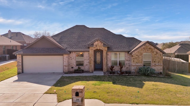 view of front of home featuring a garage, a front yard, and cooling unit