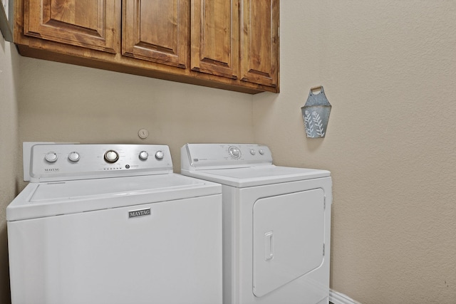 laundry room with cabinets and separate washer and dryer