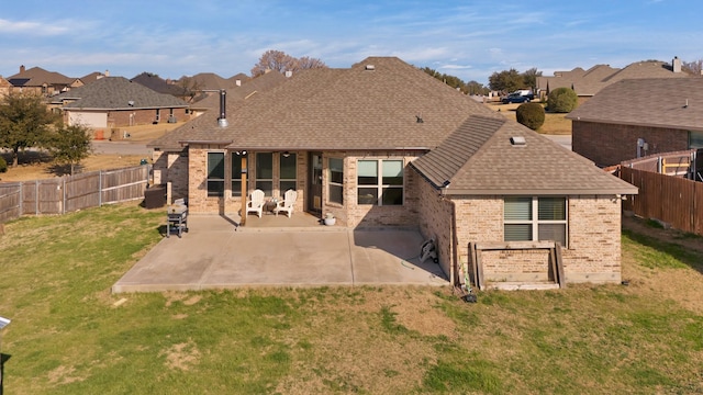 back of house with a patio and a lawn