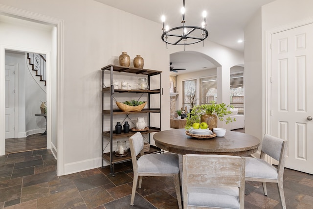 dining room featuring ceiling fan with notable chandelier