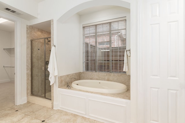 bathroom with tile patterned flooring and separate shower and tub