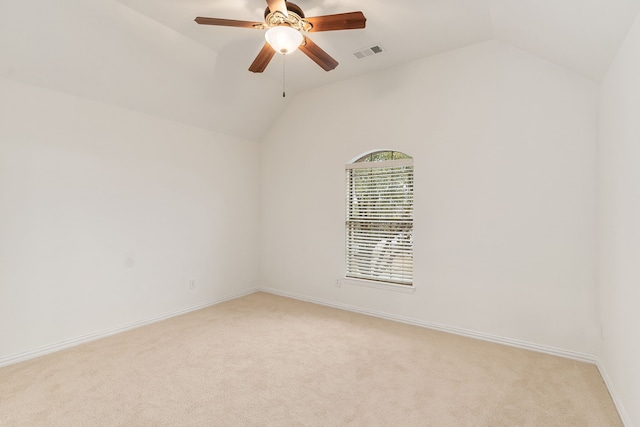 carpeted empty room featuring ceiling fan and lofted ceiling