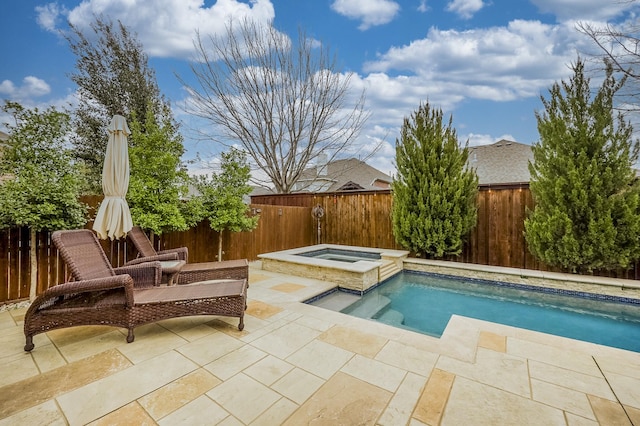 view of swimming pool featuring an in ground hot tub and a patio