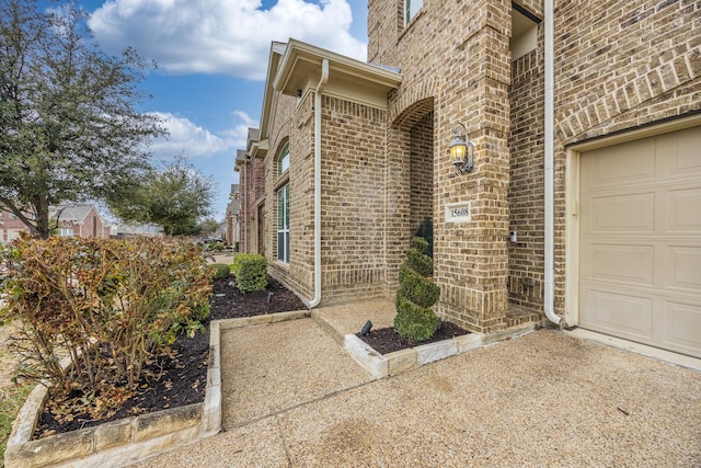 doorway to property with a garage