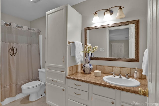 bathroom featuring vanity, tile patterned flooring, and toilet