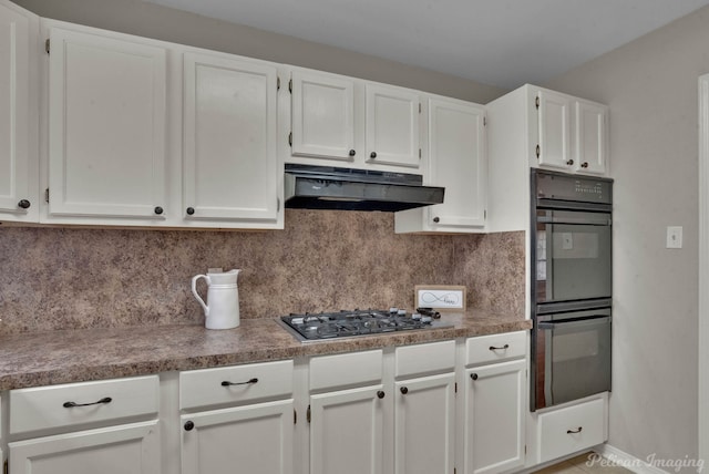 kitchen with white cabinetry, tasteful backsplash, black double oven, and stainless steel gas cooktop