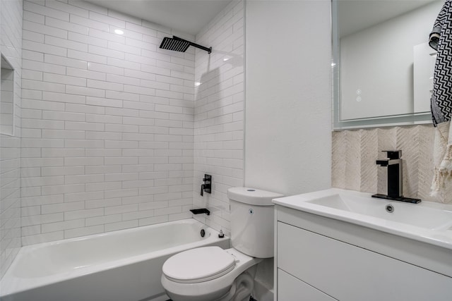 full bathroom featuring tiled shower / bath combo, vanity, and toilet