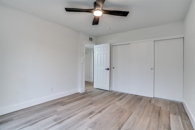 unfurnished bedroom featuring light hardwood / wood-style floors, a closet, and ceiling fan