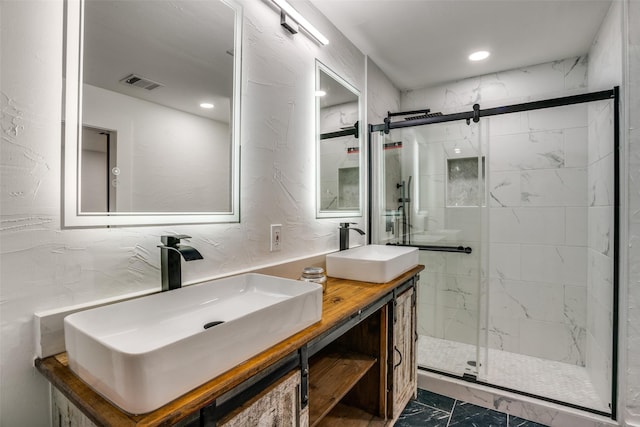 bathroom featuring vanity and a shower with shower door