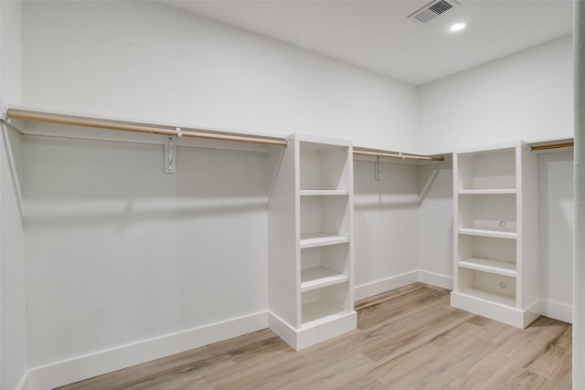 spacious closet featuring light hardwood / wood-style floors