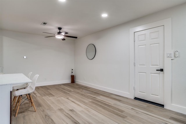 unfurnished office featuring ceiling fan and light wood-type flooring