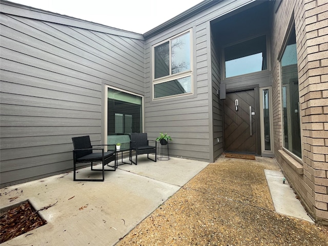 property entrance featuring a patio