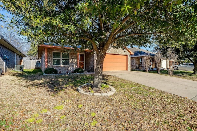 414 Tinker Trl, Burleson, TX 76028 - view of front of property featuring central AC unit, a garage, brick siding, and driveway