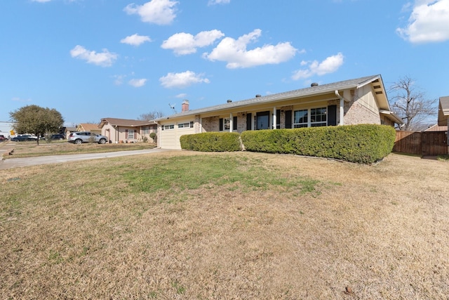 single story home featuring a garage and a front yard