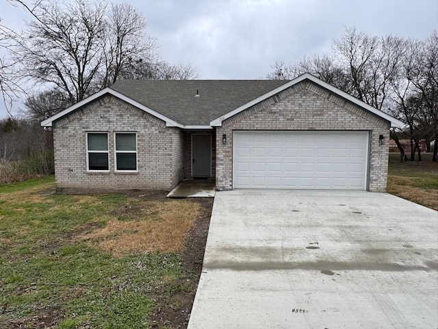 single story home featuring a garage and a front yard