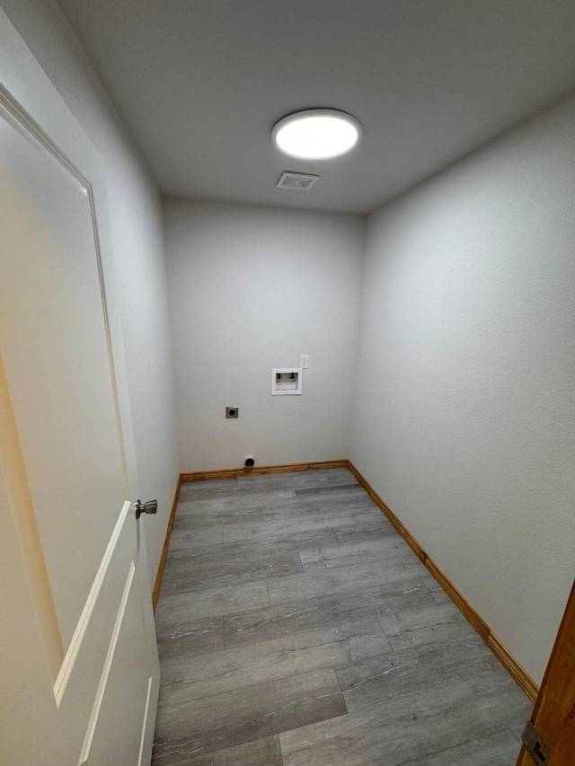 washroom with light hardwood / wood-style floors and hookup for a washing machine