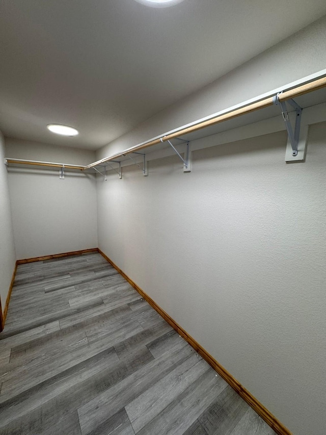 spacious closet with light hardwood / wood-style flooring