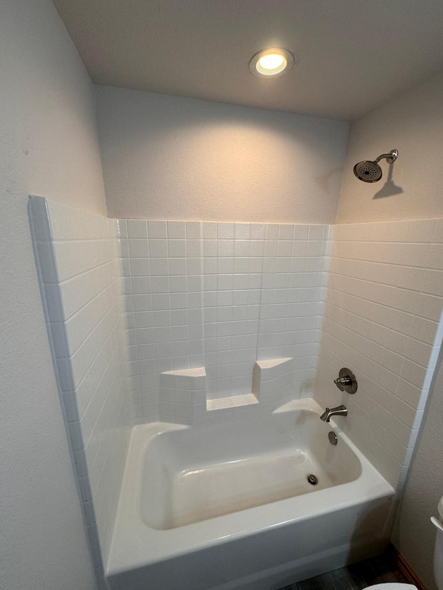 bathroom featuring shower / bathtub combination and toilet