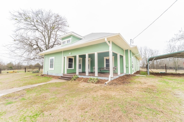 view of front facade with covered porch and a front yard