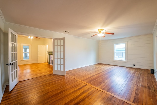 unfurnished room featuring ornamental molding, hardwood / wood-style floors, ceiling fan, and french doors